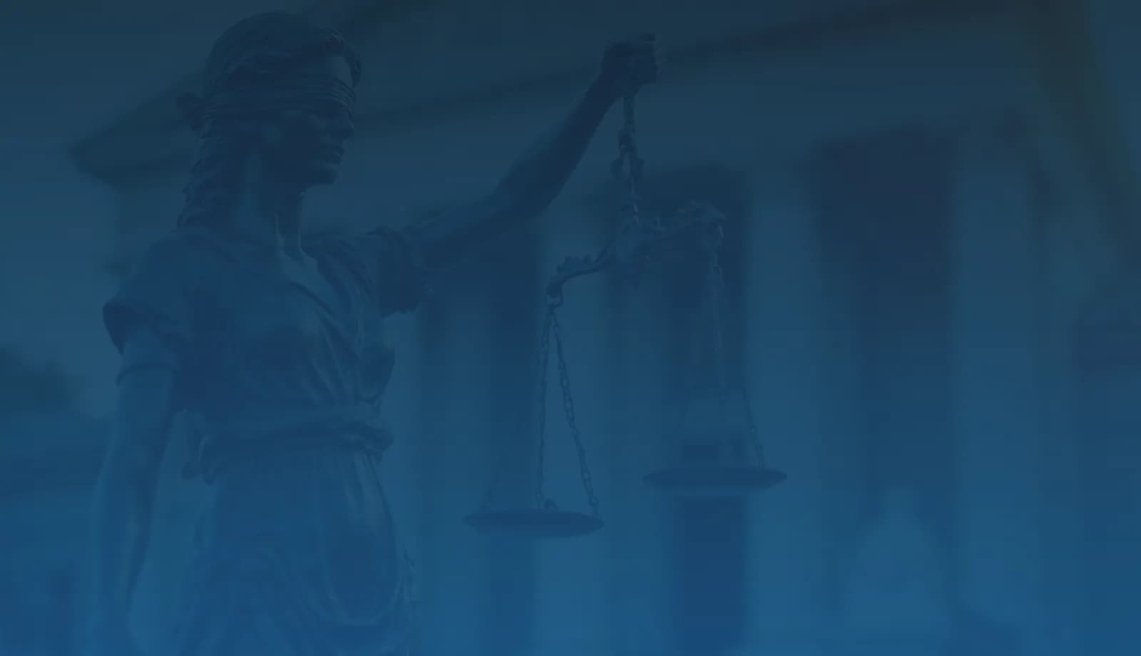 Statue of Lady Justice holding scales against a backdrop of a courthouse