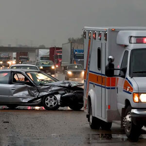 An image depicts a car crash on the highway, showcasing the damaged vehicle - Charles Injury Law.