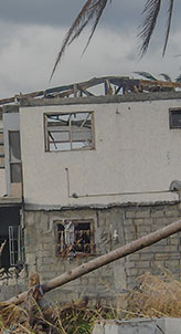 A house in ruins after a hurricane, with collapsed sections and debris - Charles Injury Law